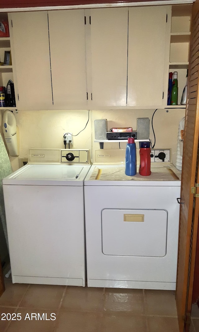 laundry area with washer and clothes dryer, cabinet space, and tile patterned floors