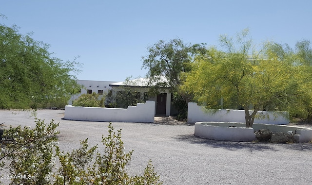 view of front of property with a fenced front yard and stucco siding