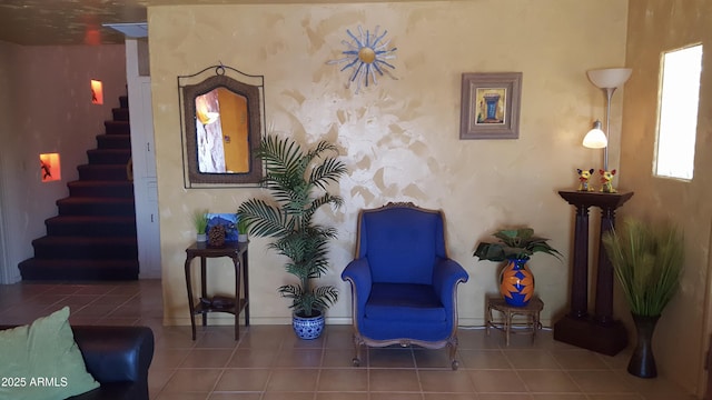 living area featuring tile patterned flooring and stairway