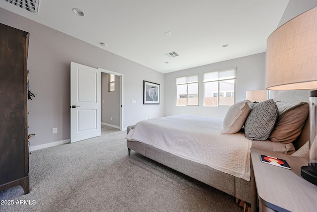 carpeted bedroom featuring baseboards and visible vents