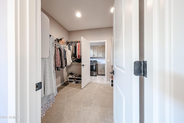 spacious closet featuring light carpet