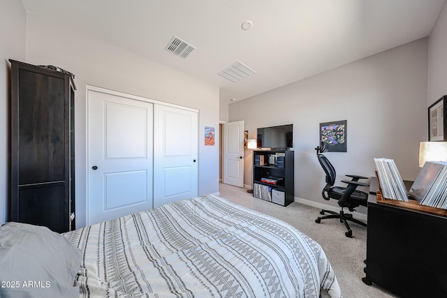 carpeted bedroom featuring visible vents, baseboards, and a closet