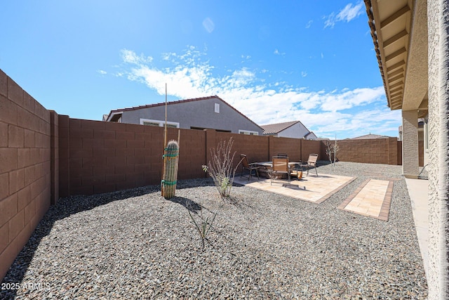 view of yard featuring a patio and a fenced backyard