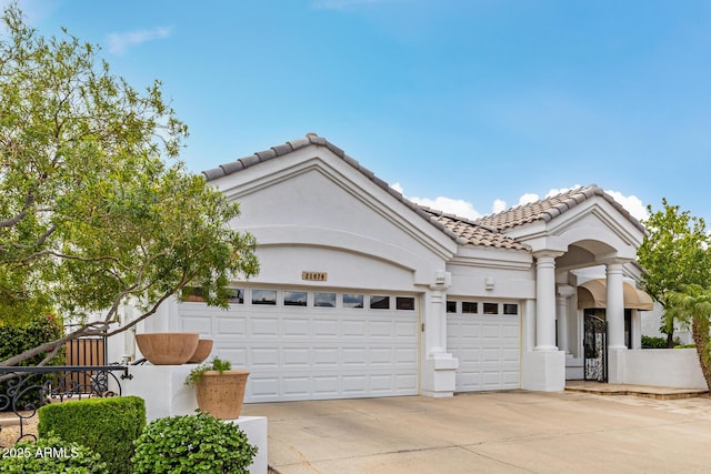 21474 N 56th Ave, Glendale, AZ 85308 - mediterranean / spanish home with a garage, driveway, stucco siding, and a tile roof