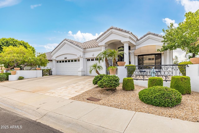 21474 N 56th Ave, Glendale, AZ 85308 - mediterranean / spanish house with an attached garage, driveway, stucco siding, and a tile roof
