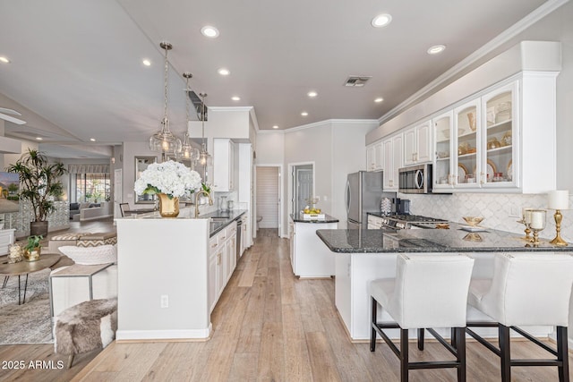 21474 N 56th Ave, Glendale, AZ 85308 - kitchen with white cabinets, a peninsula, visible vents, and stainless steel appliances