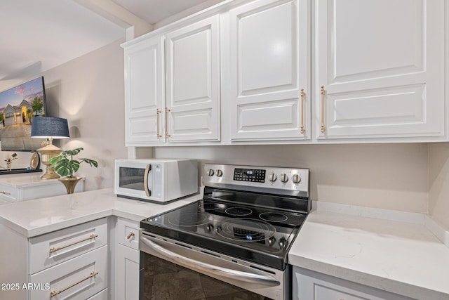 21474 N 56th Ave, Glendale, AZ 85308 - kitchen with white microwave, a peninsula, white cabinets, light stone counters, and stainless steel electric range