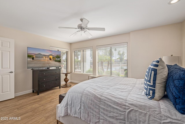 21474 N 56th Ave, Glendale, AZ 85308 - bedroom with light wood finished floors, baseboards, and ceiling fan