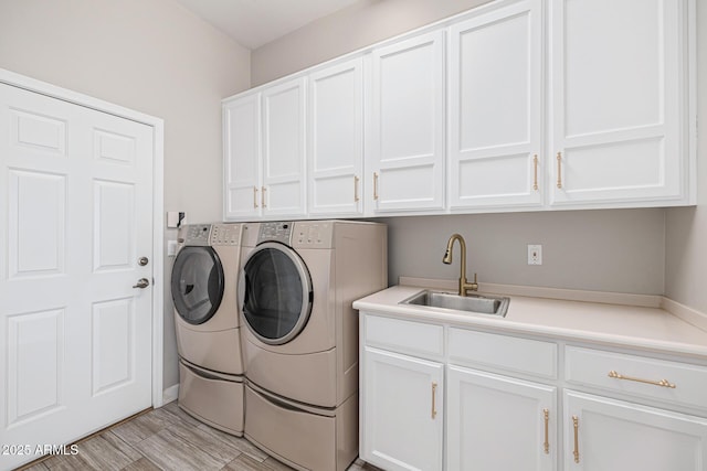 21474 N 56th Ave, Glendale, AZ 85308 - clothes washing area with independent washer and dryer, a sink, cabinet space, and light wood-style flooring