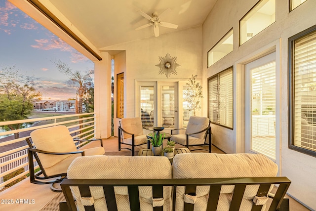 21474 N 56th Ave, Glendale, AZ 85308 - patio terrace at dusk with outdoor lounge area, a ceiling fan, and a balcony