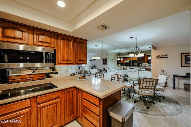 kitchen with hanging light fixtures, kitchen peninsula, light tile floors, and crown molding