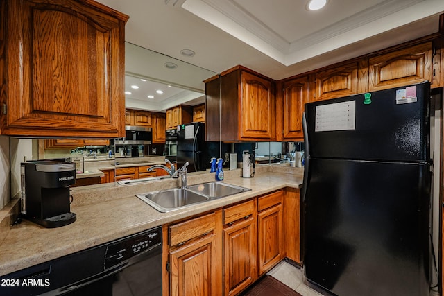 kitchen with ornamental molding, a tray ceiling, sink, and black appliances