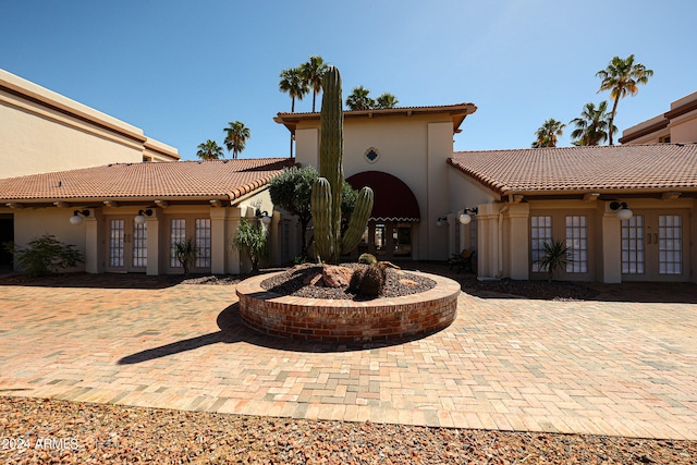 view of front facade featuring a patio area and french doors