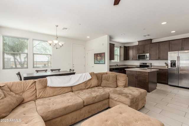 living area featuring a healthy amount of sunlight, visible vents, and recessed lighting