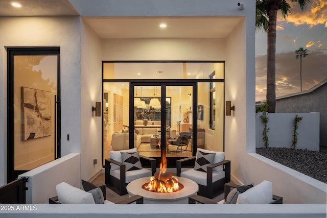 interior space with an outdoor living space with a fire pit