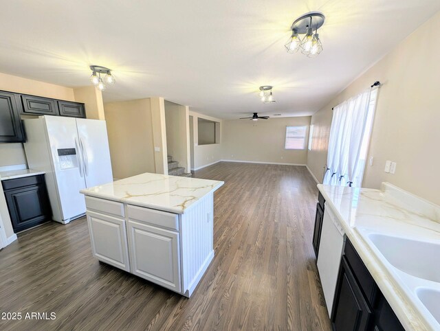 22523 W Pima St, Buckeye, AZ 85326 - kitchen with white appliances, a ceiling fan, dark wood-style floors, a center island, and open floor plan