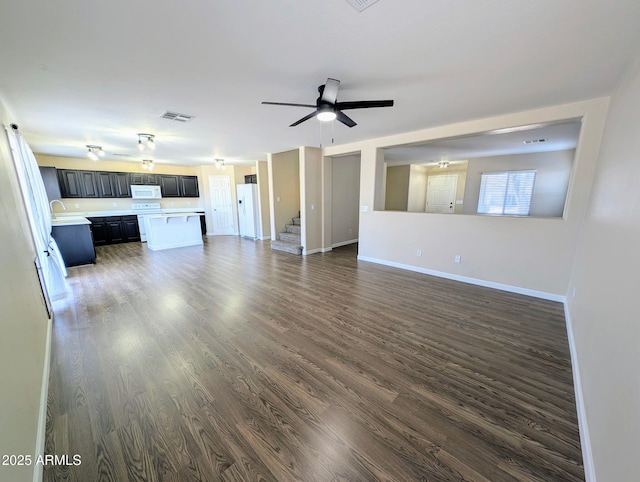 22523 W Pima St, Buckeye, AZ 85326 - unfurnished living room with stairway, dark wood-style flooring, and a ceiling fan