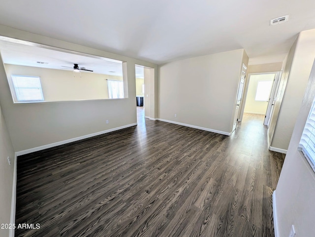 22523 W Pima St, Buckeye, AZ 85326 - spare room with dark wood finished floors, ceiling fan, and plenty of natural light