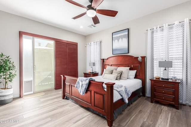 bedroom with connected bathroom, light hardwood / wood-style flooring, and ceiling fan