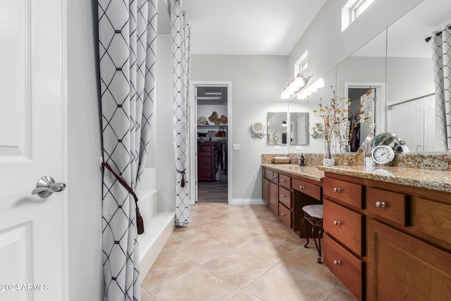 bathroom featuring vanity, curtained shower, and tile patterned floors