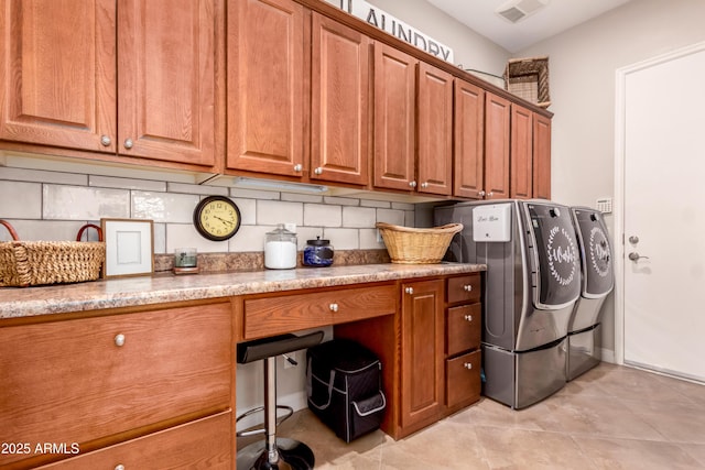 laundry room with cabinets, separate washer and dryer, and light tile patterned floors