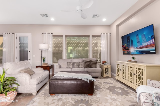 tiled living room with ceiling fan