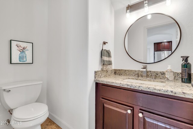 21167 E Aspen Valley Dr, Queen Creek, AZ 85142 - half bathroom with vanity, toilet, and baseboards