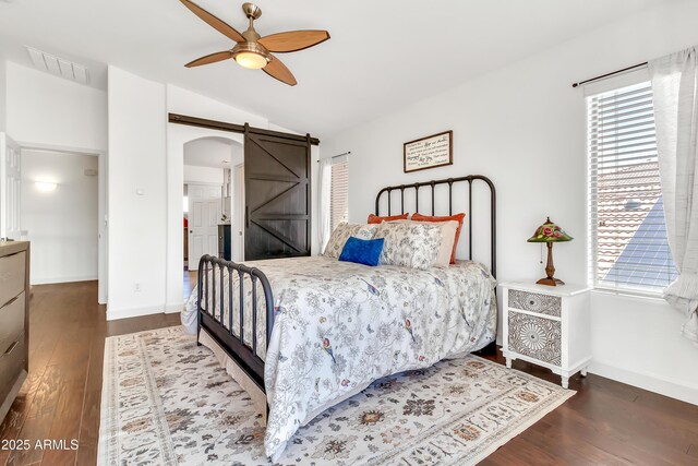 21167 E Aspen Valley Dr, Queen Creek, AZ 85142 - bedroom with a barn door, wood finished floors, baseboards, lofted ceiling, and arched walkways
