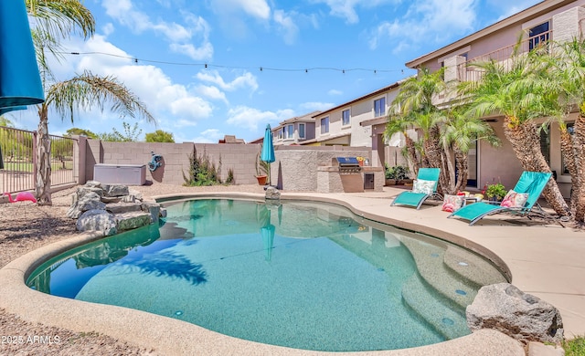 21167 E Aspen Valley Dr, Queen Creek, AZ 85142 - view of swimming pool featuring a fenced backyard, an outdoor kitchen, and a patio area