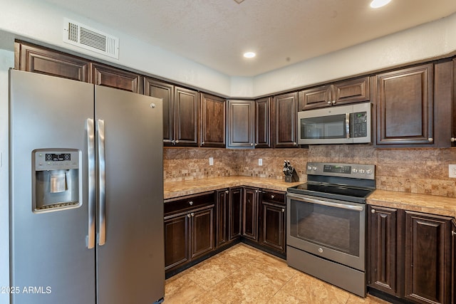 215 S 132nd St, Chandler, AZ 85225 - kitchen with stainless steel appliances, light countertops, dark brown cabinets, tasteful backsplash, and recessed lighting