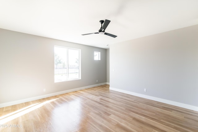 empty room featuring ceiling fan and light hardwood / wood-style flooring