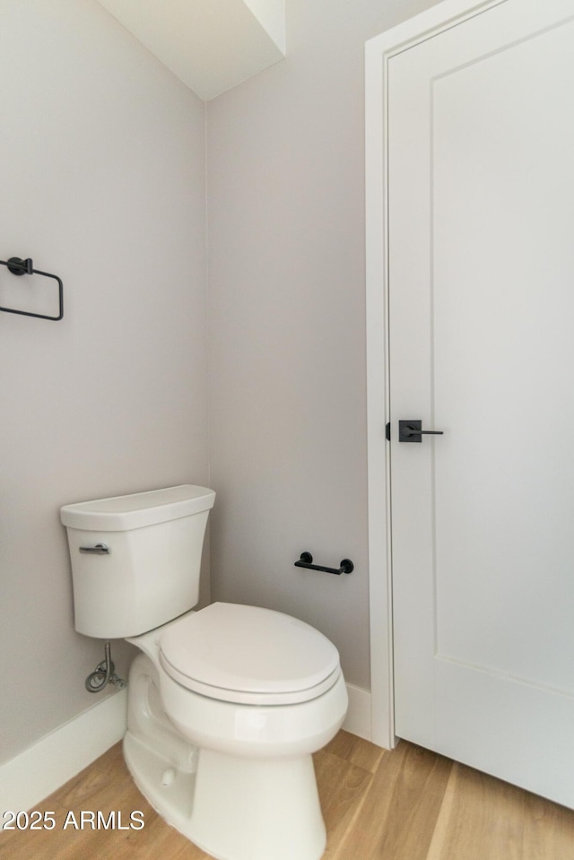 bathroom featuring toilet and hardwood / wood-style floors