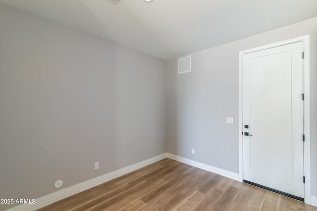 spare room with light hardwood / wood-style floors