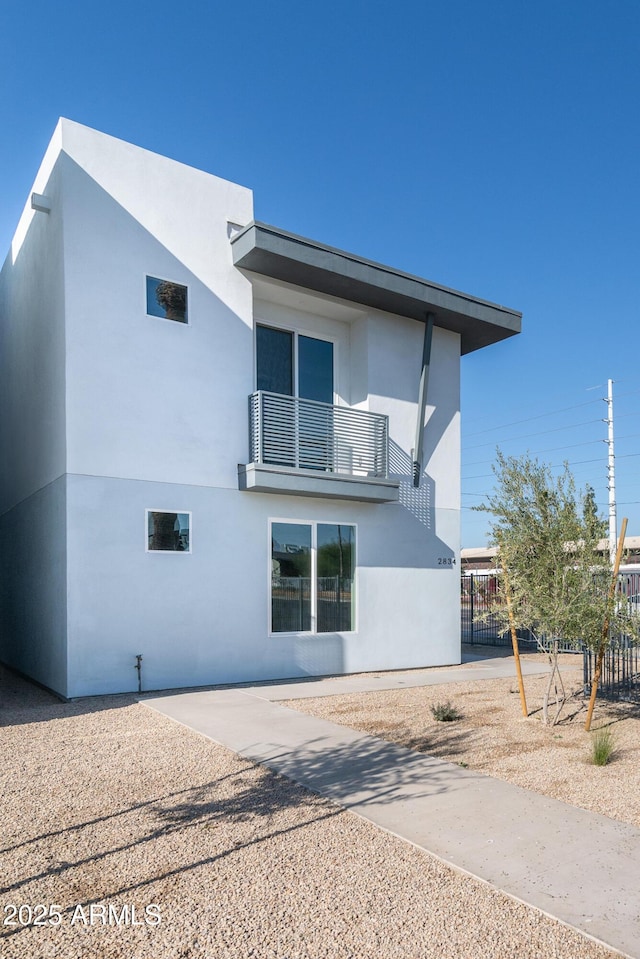 rear view of house with a balcony and a patio area