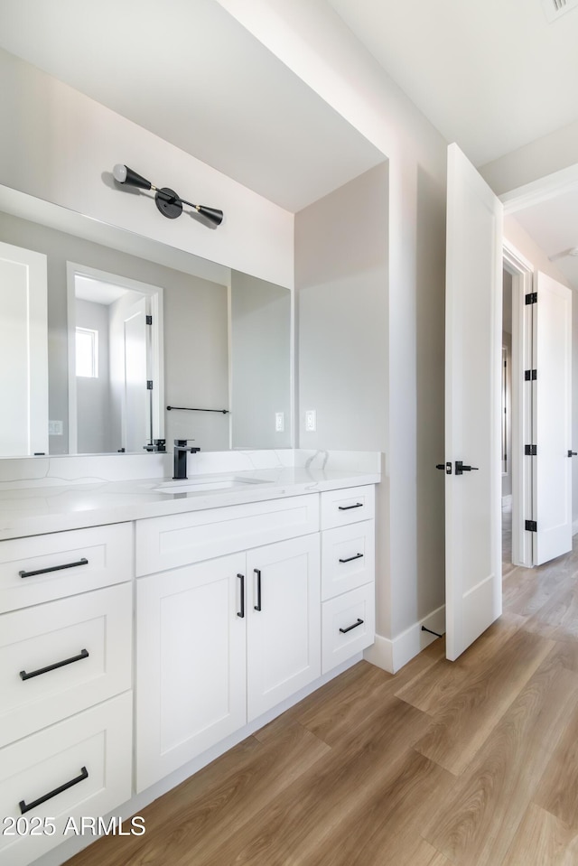 bathroom featuring vanity and wood-type flooring