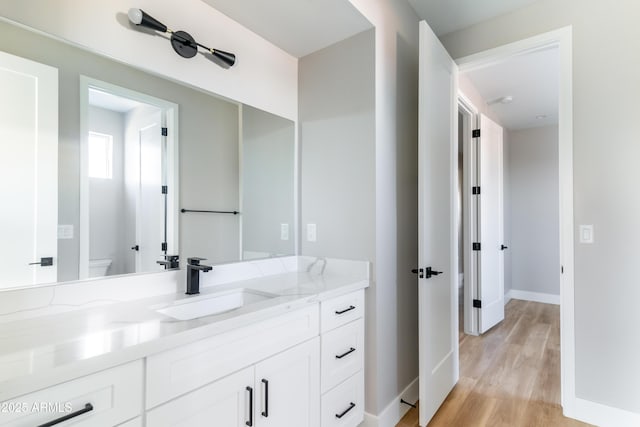 bathroom featuring hardwood / wood-style floors, toilet, and vanity