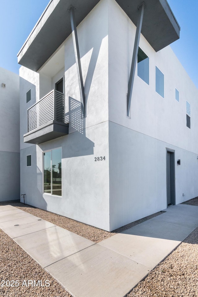 view of side of home with a balcony