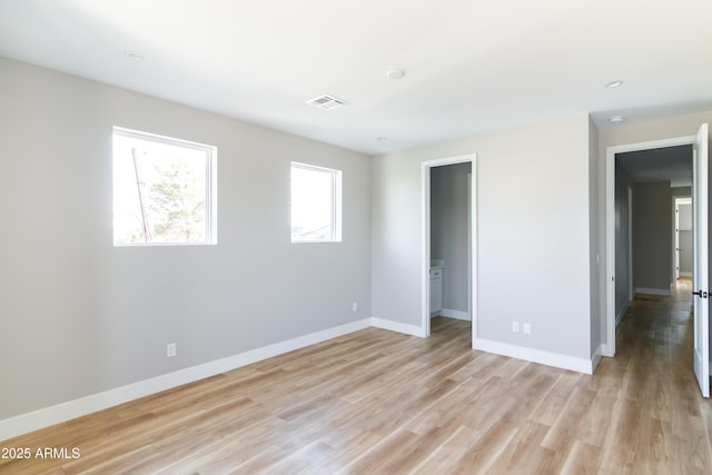 empty room with light hardwood / wood-style floors