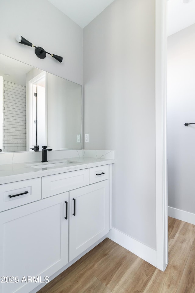 bathroom featuring hardwood / wood-style flooring and vanity