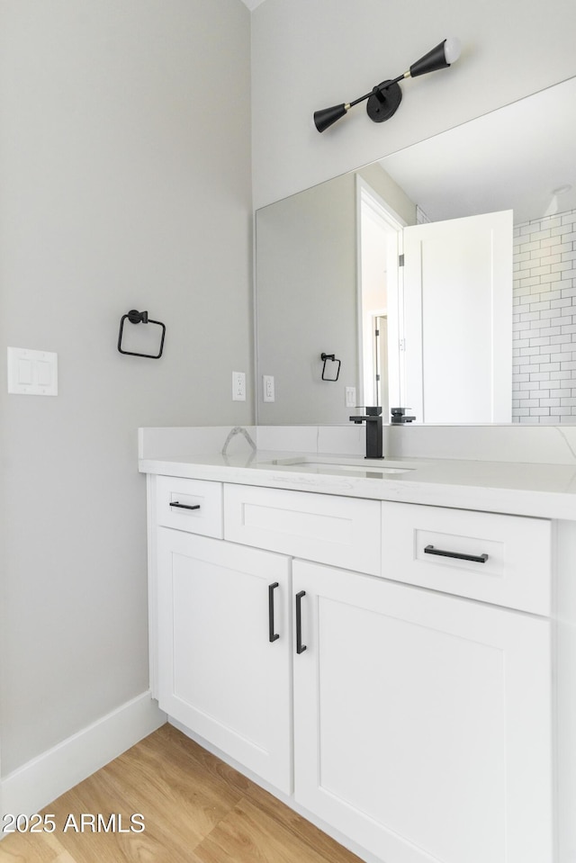 bathroom featuring wood-type flooring and vanity