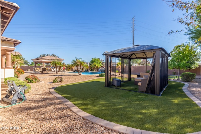 view of yard featuring a gazebo, a fenced in pool, and a patio