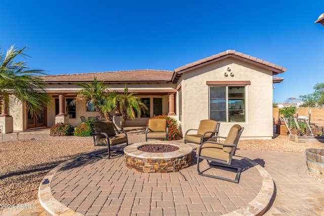 back of house featuring a patio area and an outdoor fire pit