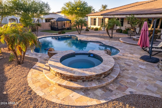 view of pool with a gazebo, an in ground hot tub, and a patio