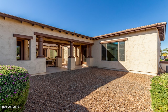 back of property with a patio