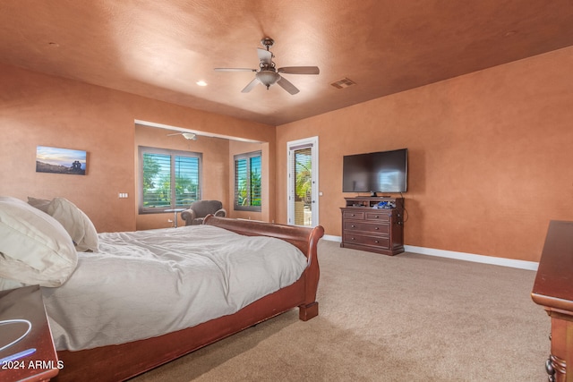 carpeted bedroom with a textured ceiling and ceiling fan