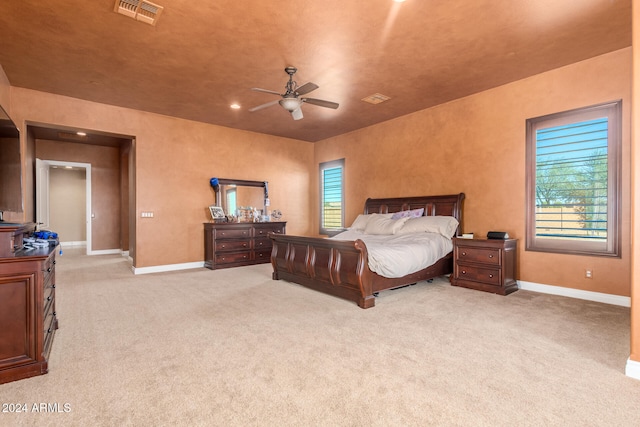 bedroom with light colored carpet and ceiling fan