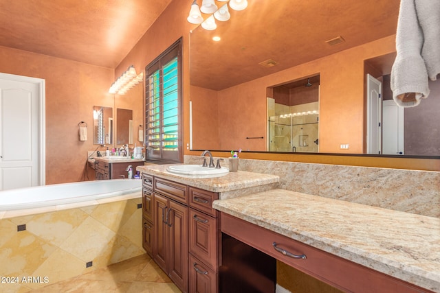 bathroom with vanity and separate shower and tub