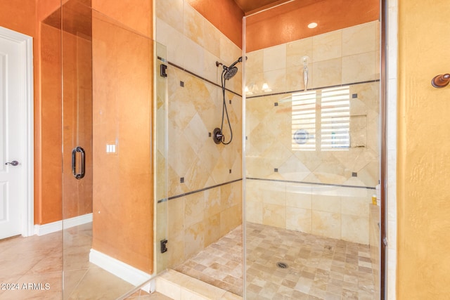 bathroom with a shower with shower door