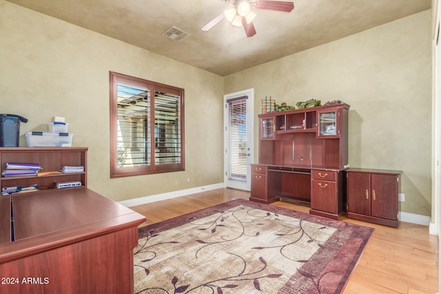 home office featuring light hardwood / wood-style floors and ceiling fan