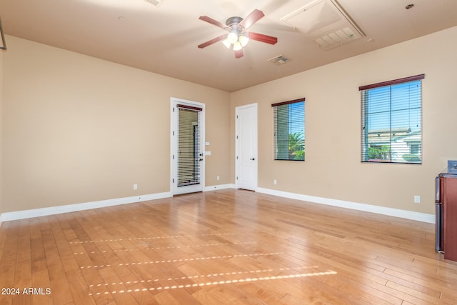 spare room with light wood-type flooring and ceiling fan